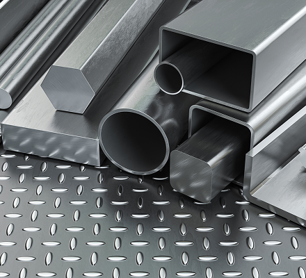 Assorted steel metal profiles, including round tubes, square tubes, rectangular tubes, hexagonal bars, and solid bars on a diamond plate surface